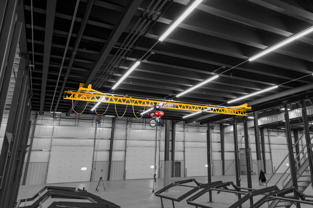 half ton pwi ceiling mounted ultra lite systems cm hoists in manufacturing setting