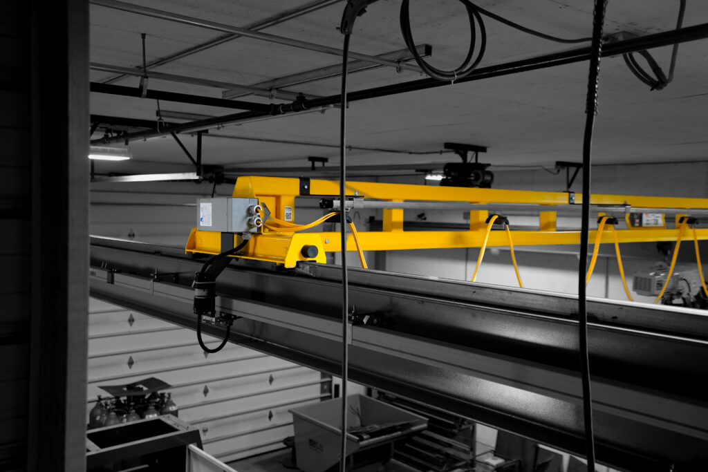 1 ton pwi freestanding hyperlite crane starke hoist with anver lifter in manufacturing setting 7