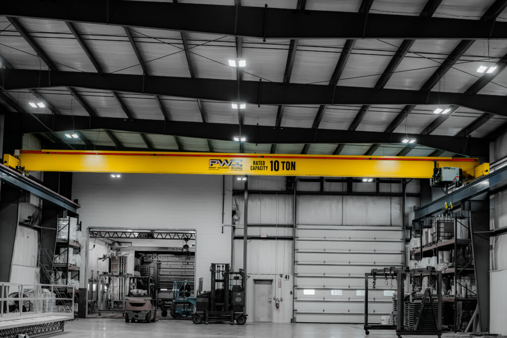10 ton pwi top running motorized crane in manufacturing setting