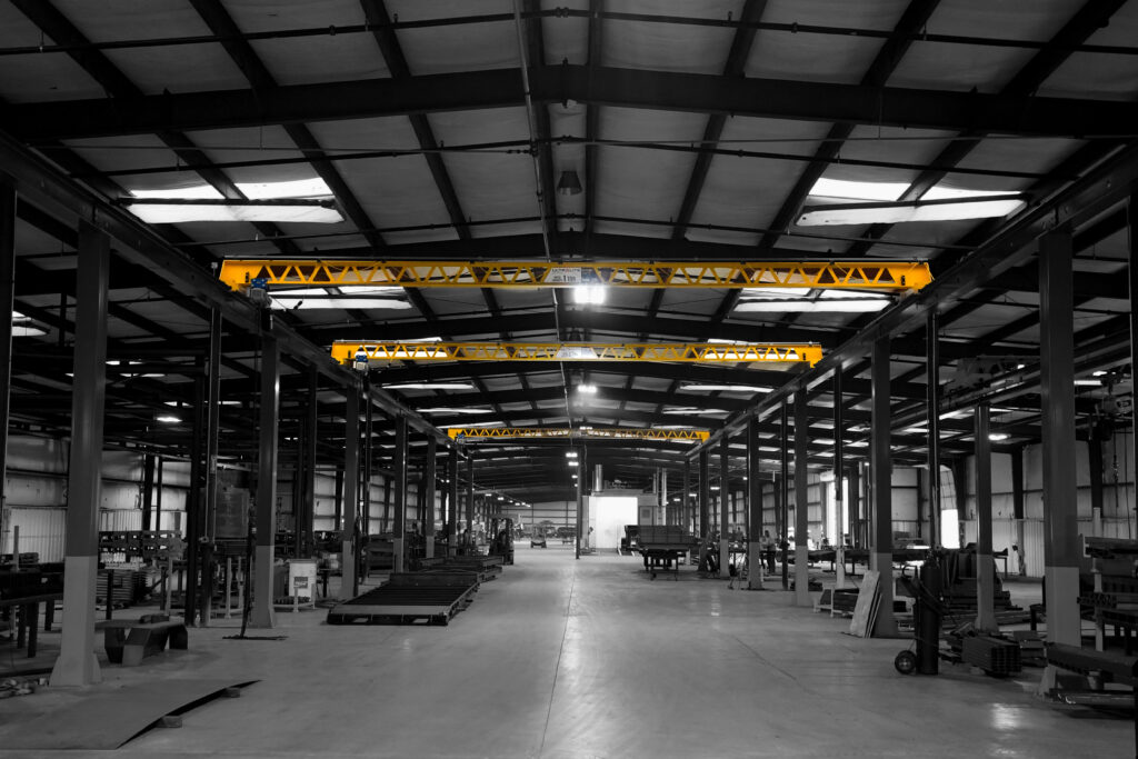 three 1 ton pwi freestanding ultralite crane system with starke hoist in trailer manufacturing setting 2