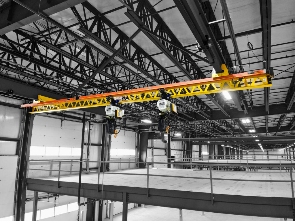 two half ton pwi ceiling mounted ultra lite systems cm hoists in manufacturing setting 3