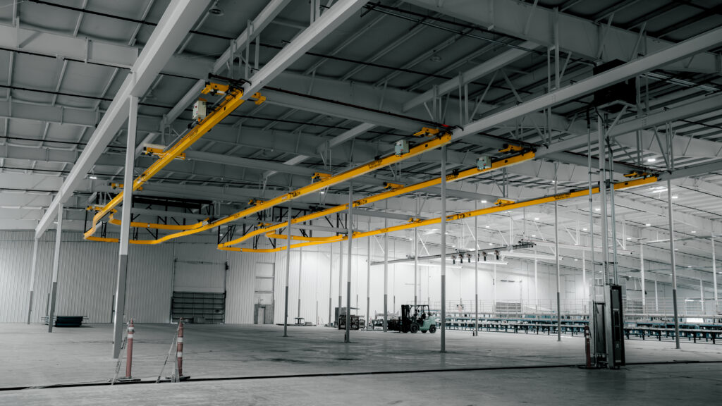 two 3 ton curved monorail cranes in manufacturing setting